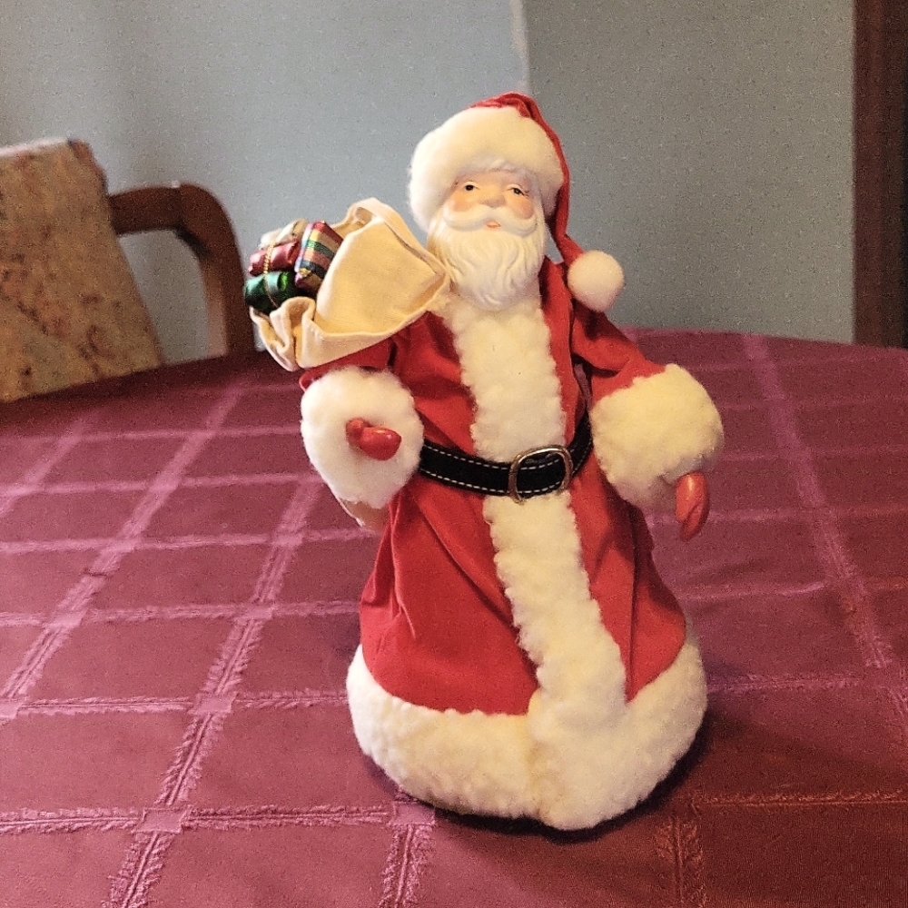 Vintage santa tree topper with bag of presents.